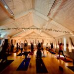 Mandala Yoga students with arms in the air
