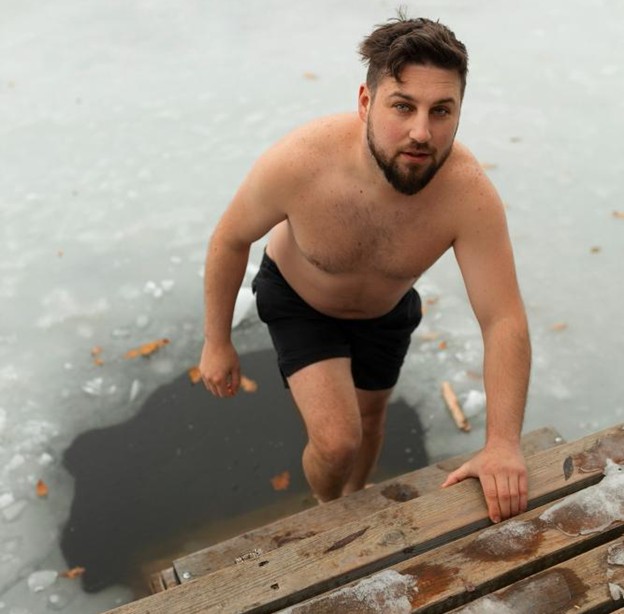 man emerging from an ice hole